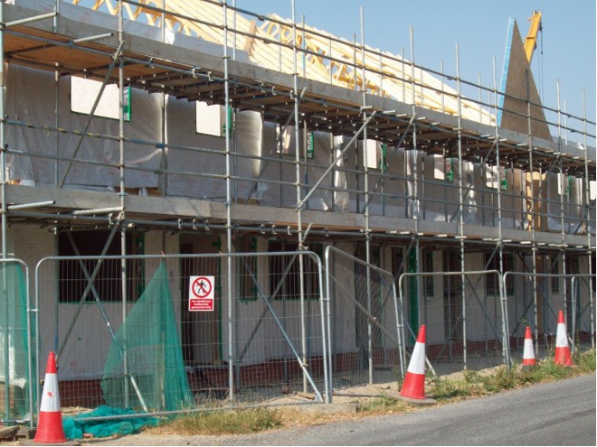 Photo of scaffolding surrounding new homes
