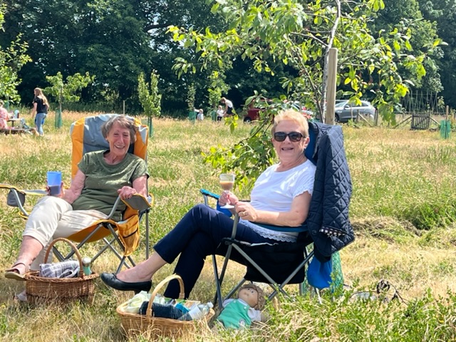 Two seated ladies at the orchard