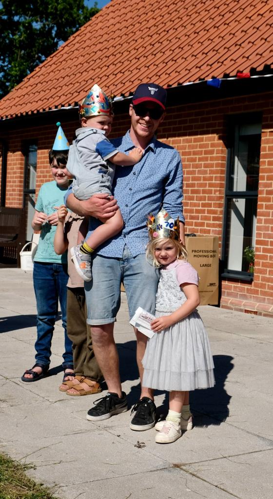A family standing outside the village hall