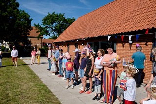 A group of people standing outside the village hall