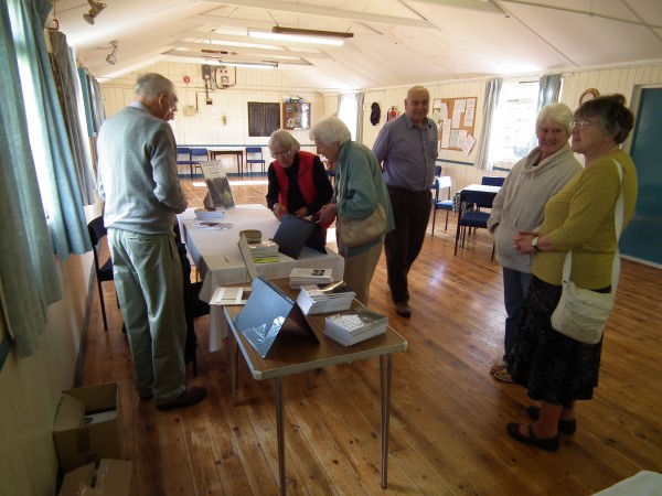 A group of people looking at the new book