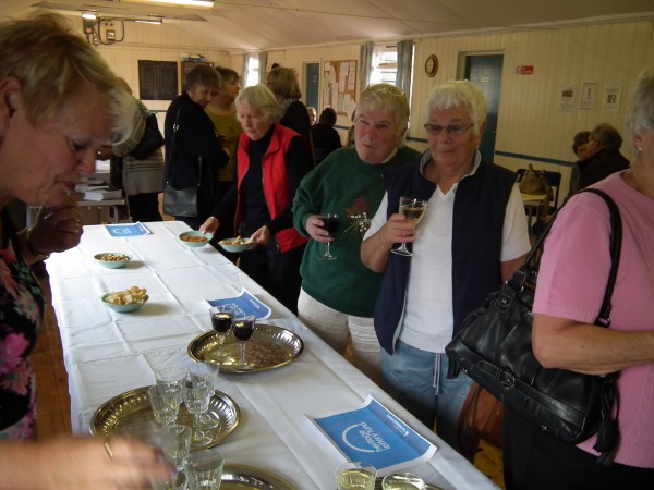 A group of people with glasses in hand at the book launch