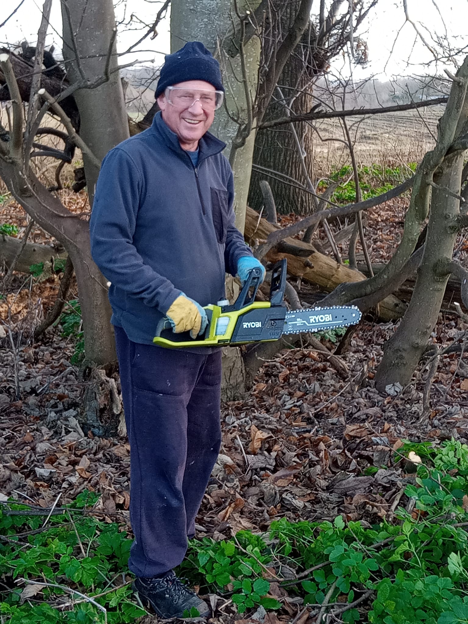 An orchard volunteer with chainsaw