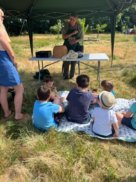 A beekeeper gives a talk at the orchard