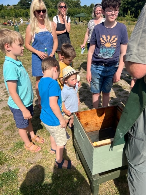 A family group learn about beekeeping