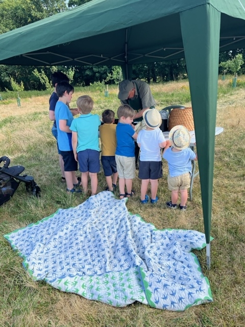 A group of children inside a marquee