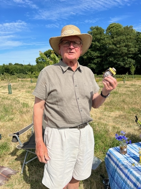 A gentleman standing at the orchard