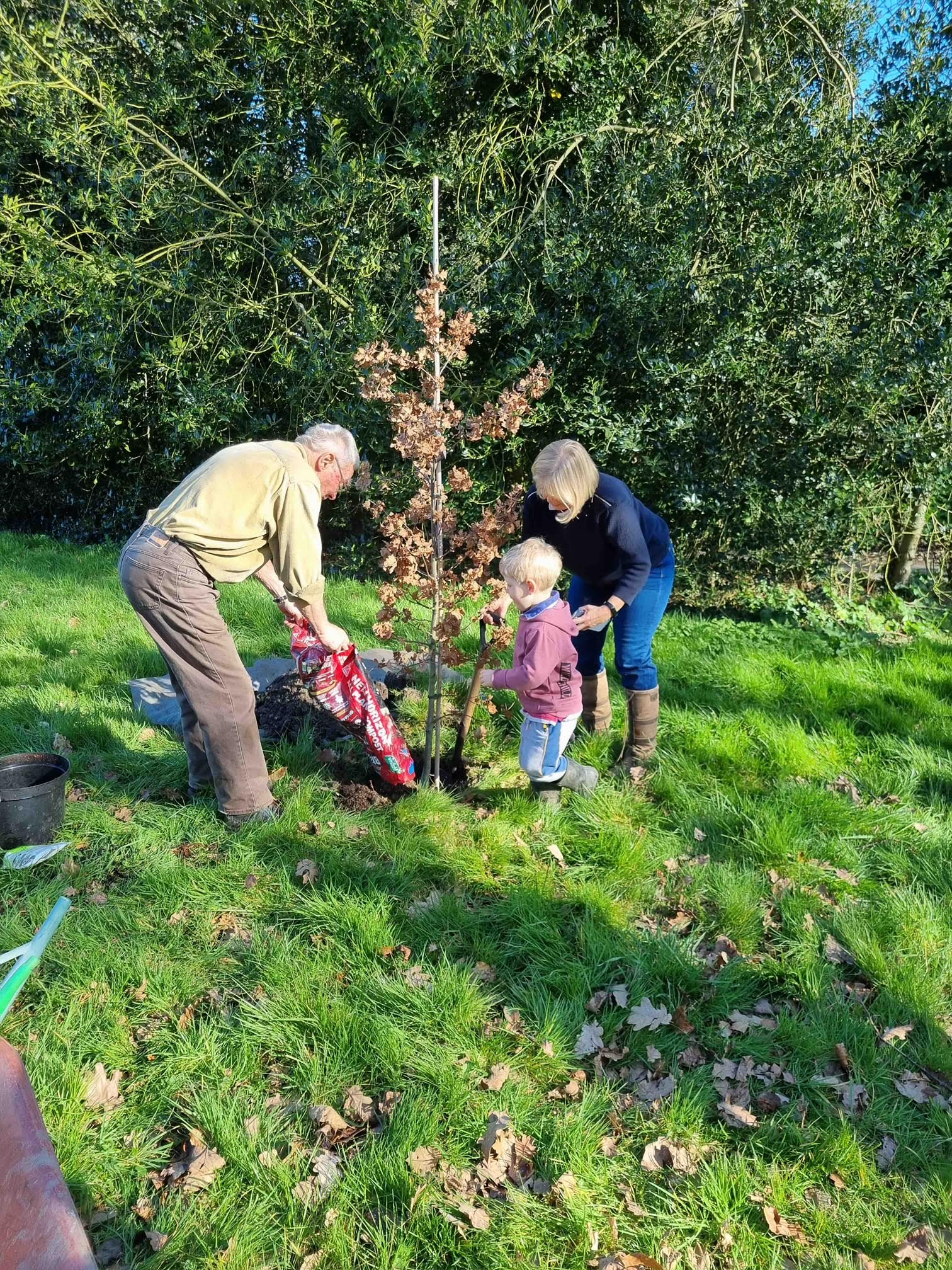Roger Coates-Smith and Jasmine Backhouse planting the jubilee tree